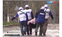 Представители ОБСЕ выносят тело погибшего